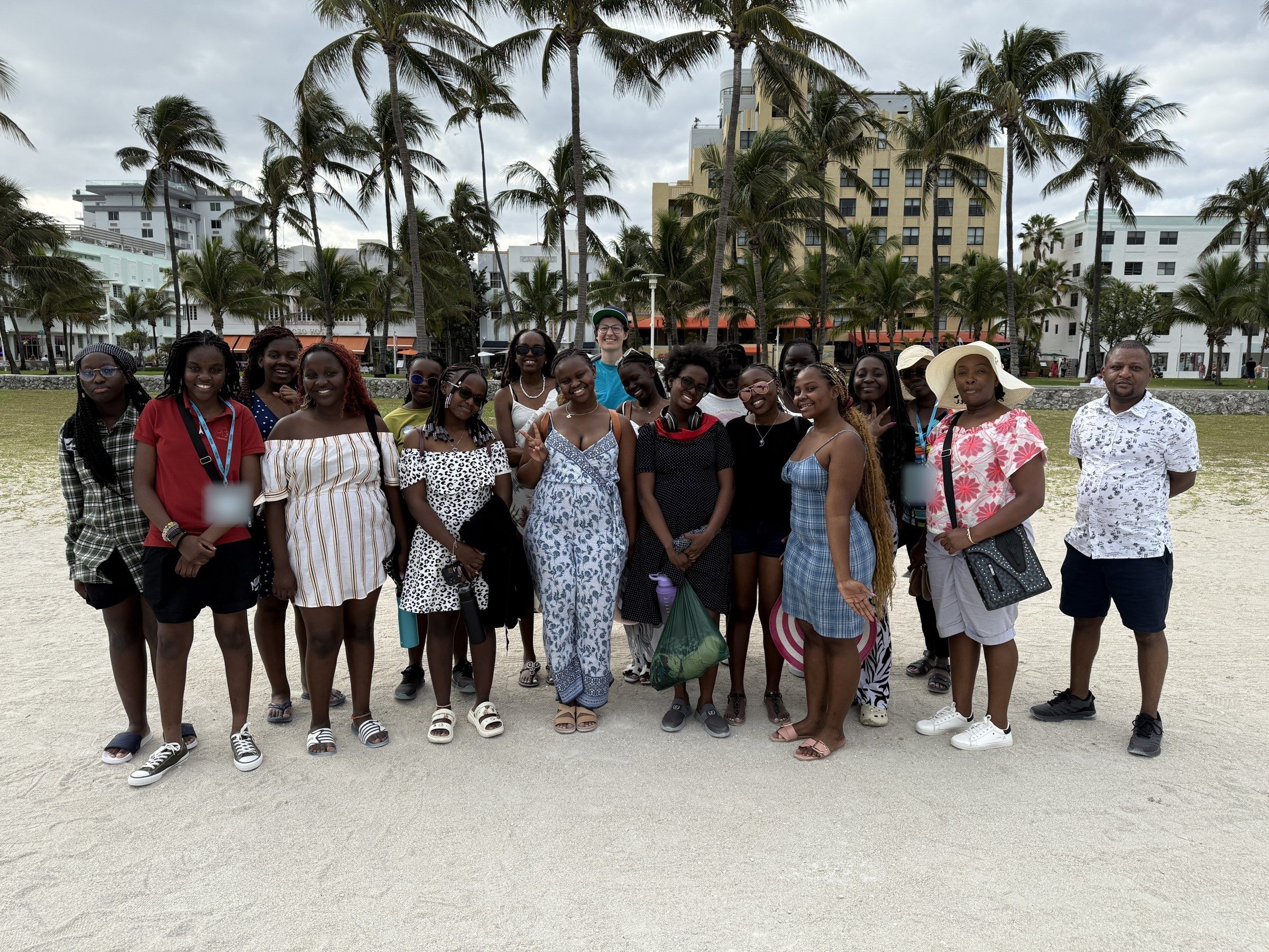 A YES USA group on South Beach, with palm trees and Art Deco hotels behind