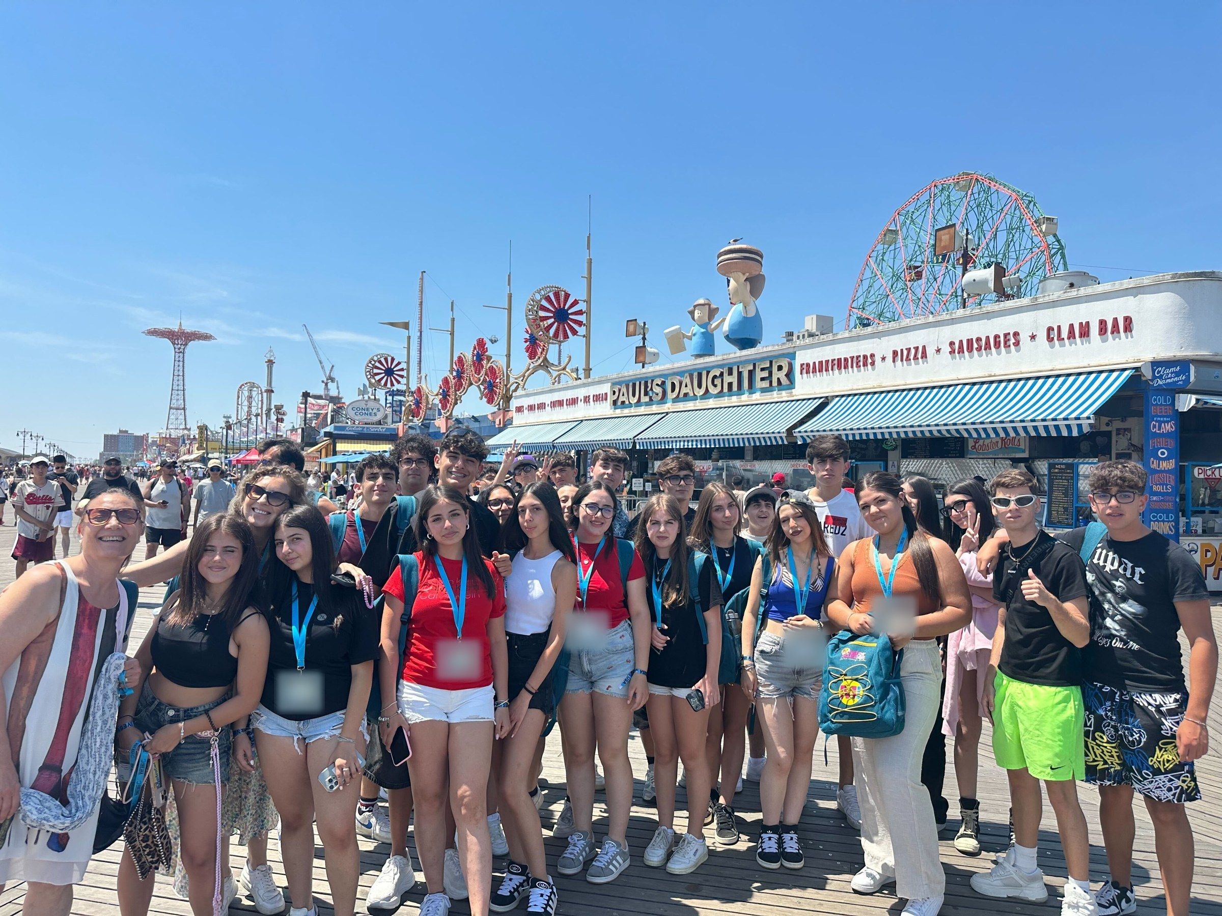 A YES USA group on the Coney Island boardwalk, with the Wonder Wheel behind