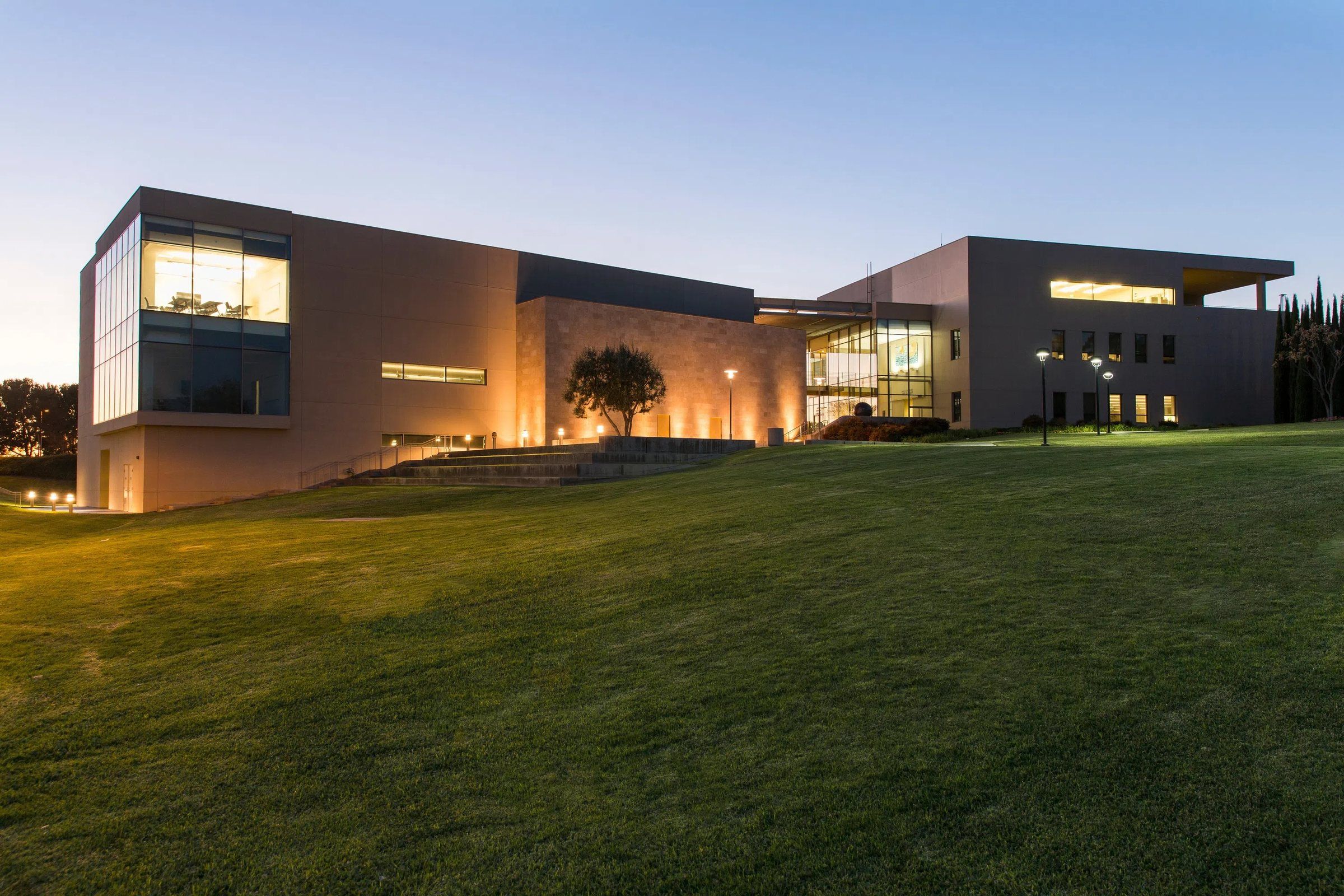 Grimm Hall and its lawn at dusk at Concordia University Irvine