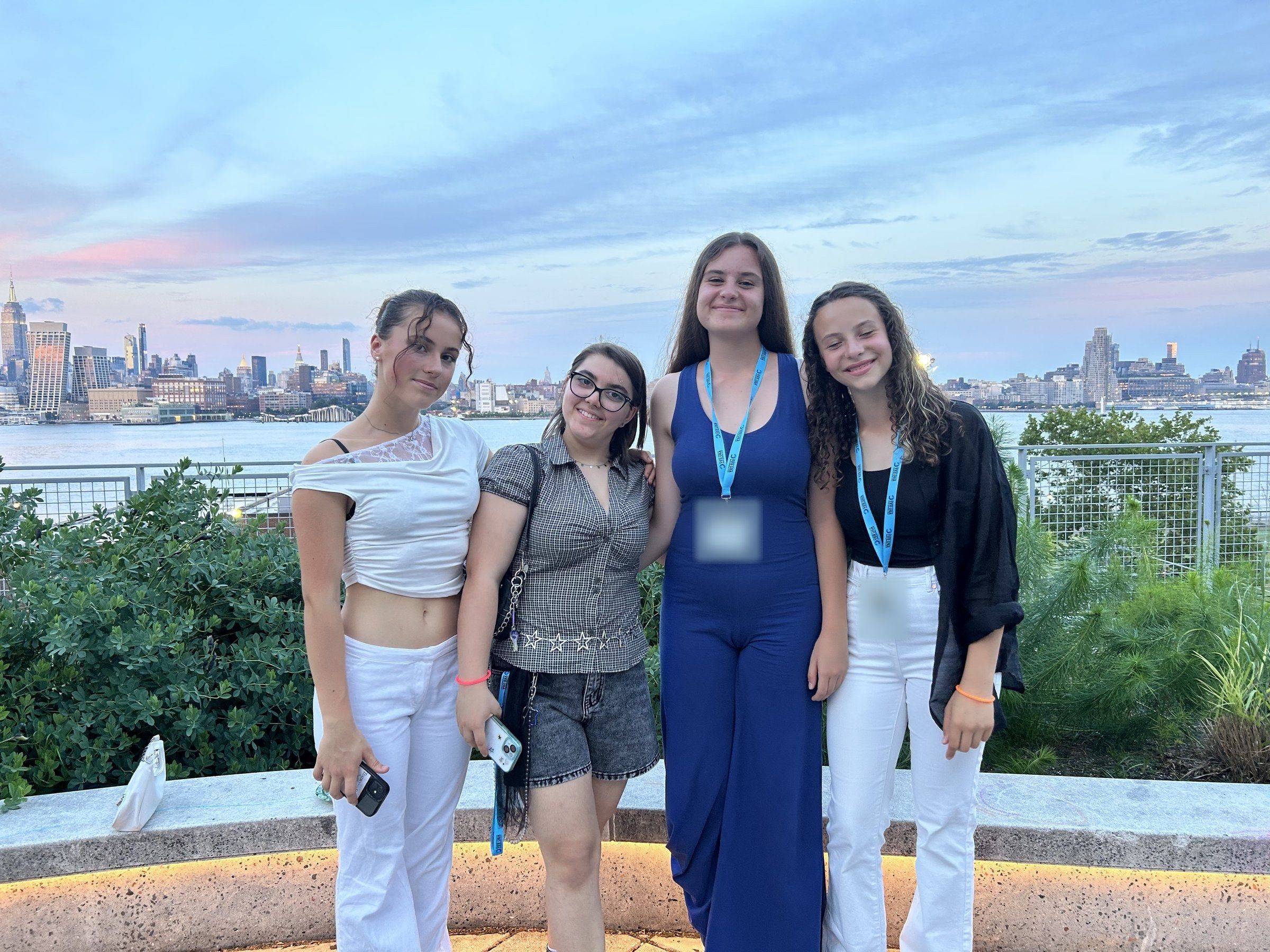 Four YES USA students at sunset with the Manhattan skyline behind them