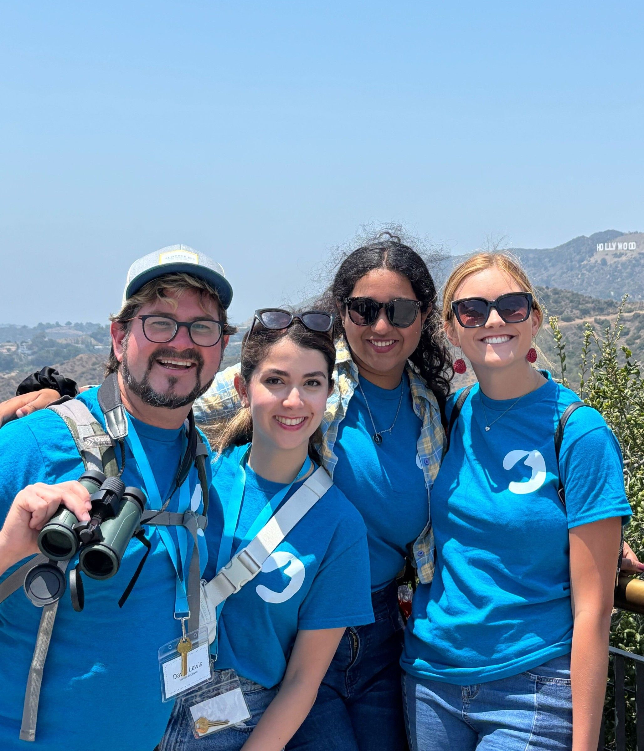 Four YES USA staff in branded shirts and lanyards at Griffith Observatory in Los Angeles