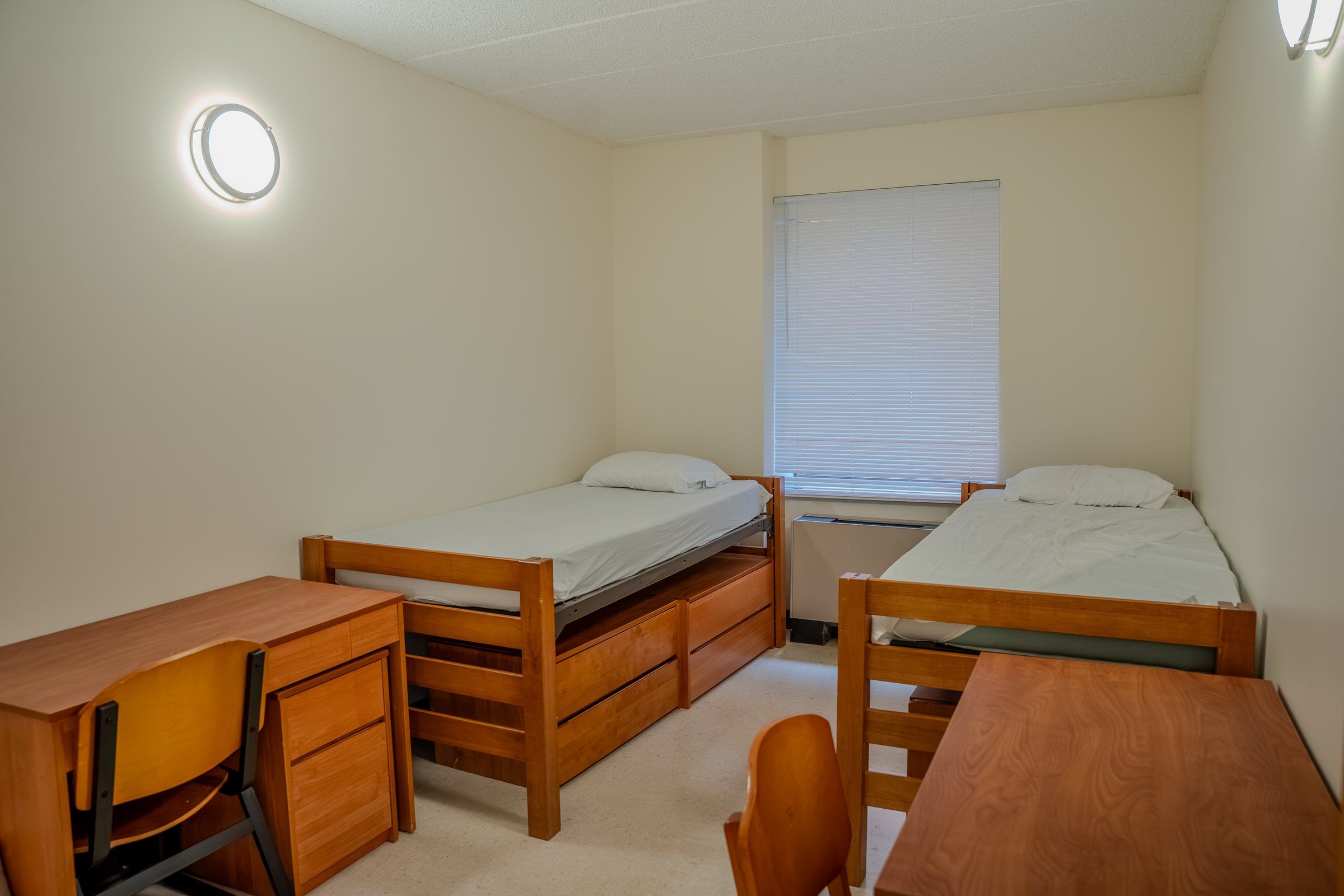 Residence room with two single beds, desks and a window at St. John's