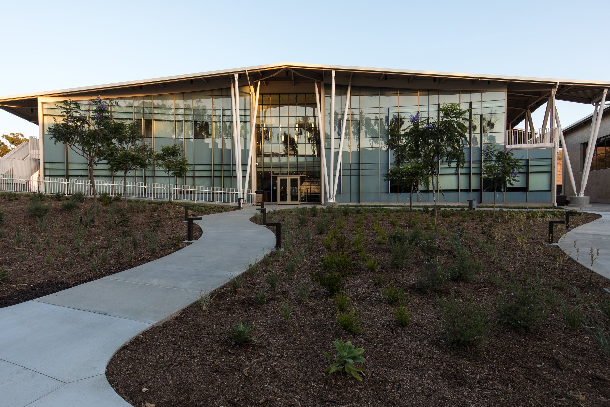 Landscaped courtyard in front of a glass building at Concordia University Irvine