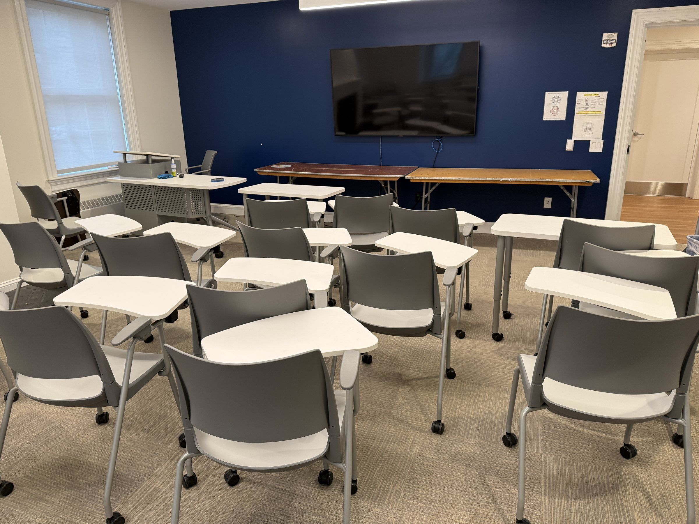 Classroom with a blue wall and screen at Stevens