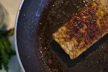 Pan fried tempeh in a pan