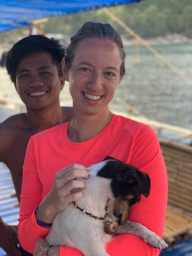 Girl and TAO Philippines boat crew member with Rosa the dog