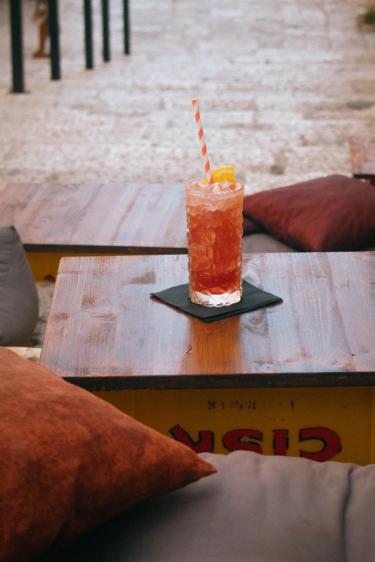 Image of a drink on repurposed drink creates to make a table. 