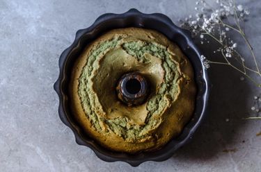 Flat lay photo of bundt cake in bundt tin surrounded by dried flowers