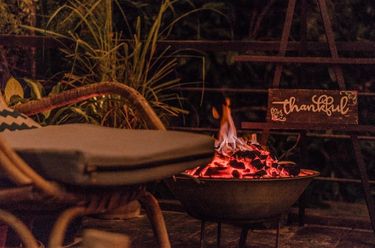 Outdoor fire at the Nesting Table of glamping boutique hotel The Birdhouse El Nido, Philippines