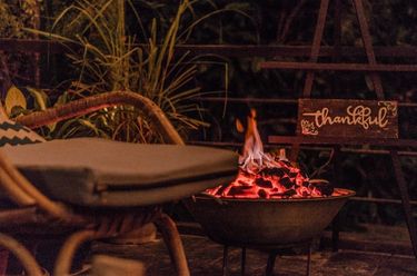 Outdoor fire at the Nesting Table of glamping boutique hotel The Birdhouse El Nido, Philippines 