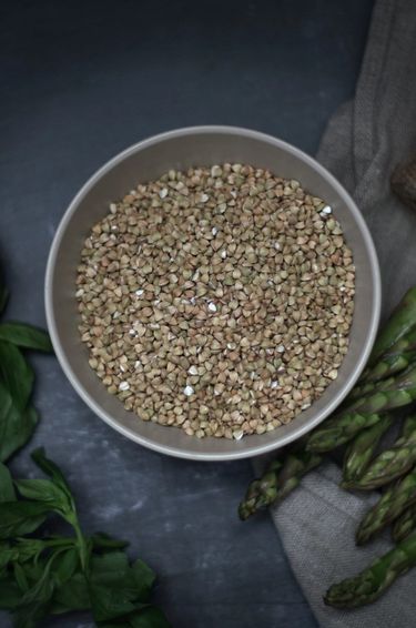 Top view of buckwheat surrounded by mint and asparagus