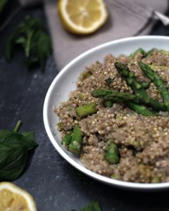 A plate with buckwheat and asparagus surrounded by lemon and mint 