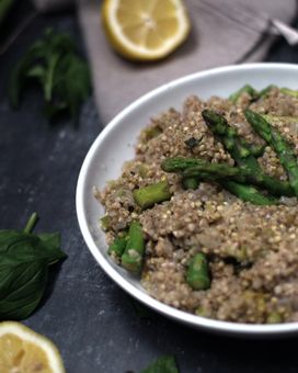A plate with buckwheat and asparagus surrounded by lemon and mint