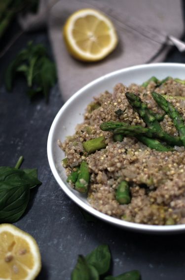 A plate with buckwheat and asparagus surrounded by lemon and mint