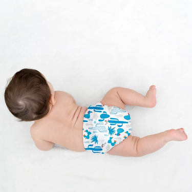 Baby in an eco diaper with a cactus pattern