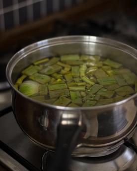 Full shot of a pot with sliced cactus pads (cactus leaves / cactus paddles / nopales) on a stove