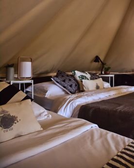 Bed in a tent at glamping boutique hotel The Birdhouse in El Nido, Philippines
