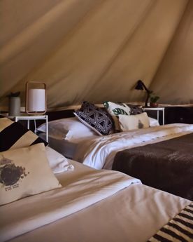 Bed in a tent at glamping boutique hotel The Birdhouse in El Nido, Philippines 