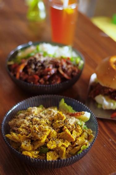 A food shot of two bowls and a burger from vegan restaurant Foam and Fork