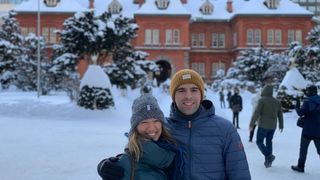 A couple posing opposite the town hall of Sapporo, Japan