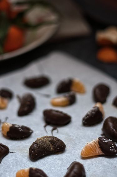 Scattered clementines coated in chocolated