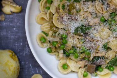 A close up of pasta with beans, peas and mushrooms 