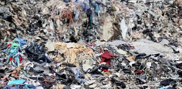 Pile of clothes due to fast fashion unsustainability