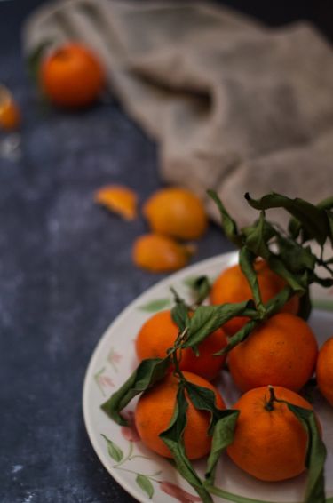 Mandarins on a plate surrounded by peel