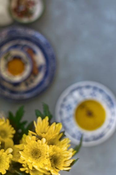 Overhead shot of turmeric milk in a bone china tea cup and saucer