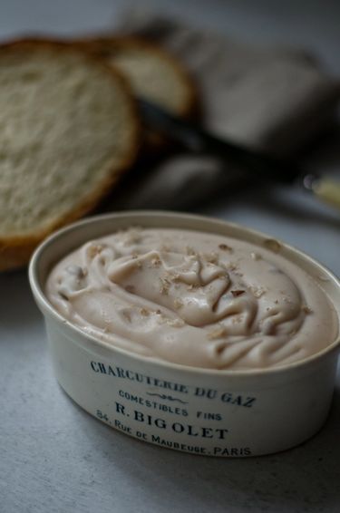 Pink butter in a ceramic dish next to toasted bread