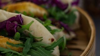 60 Degree angle close up of bao buns (gua bao) in a bamboo steamer