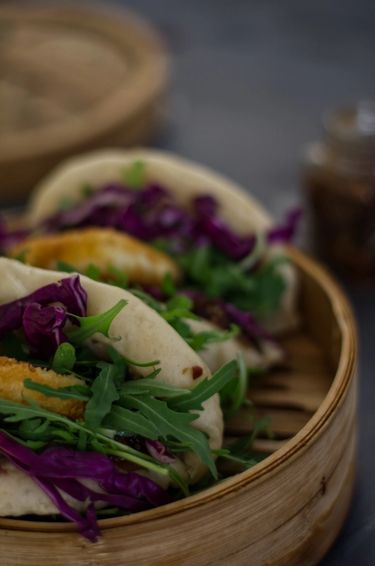 60 Degree angle close up of bao buns (gua bao) in a bamboo steamer