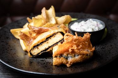 Seaweed-wrapped tofu fried in batter with a side of fries and sauce. 