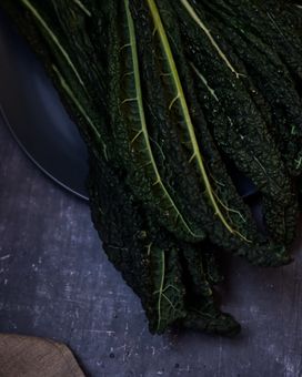 Kale leaves on a plate on a blue background