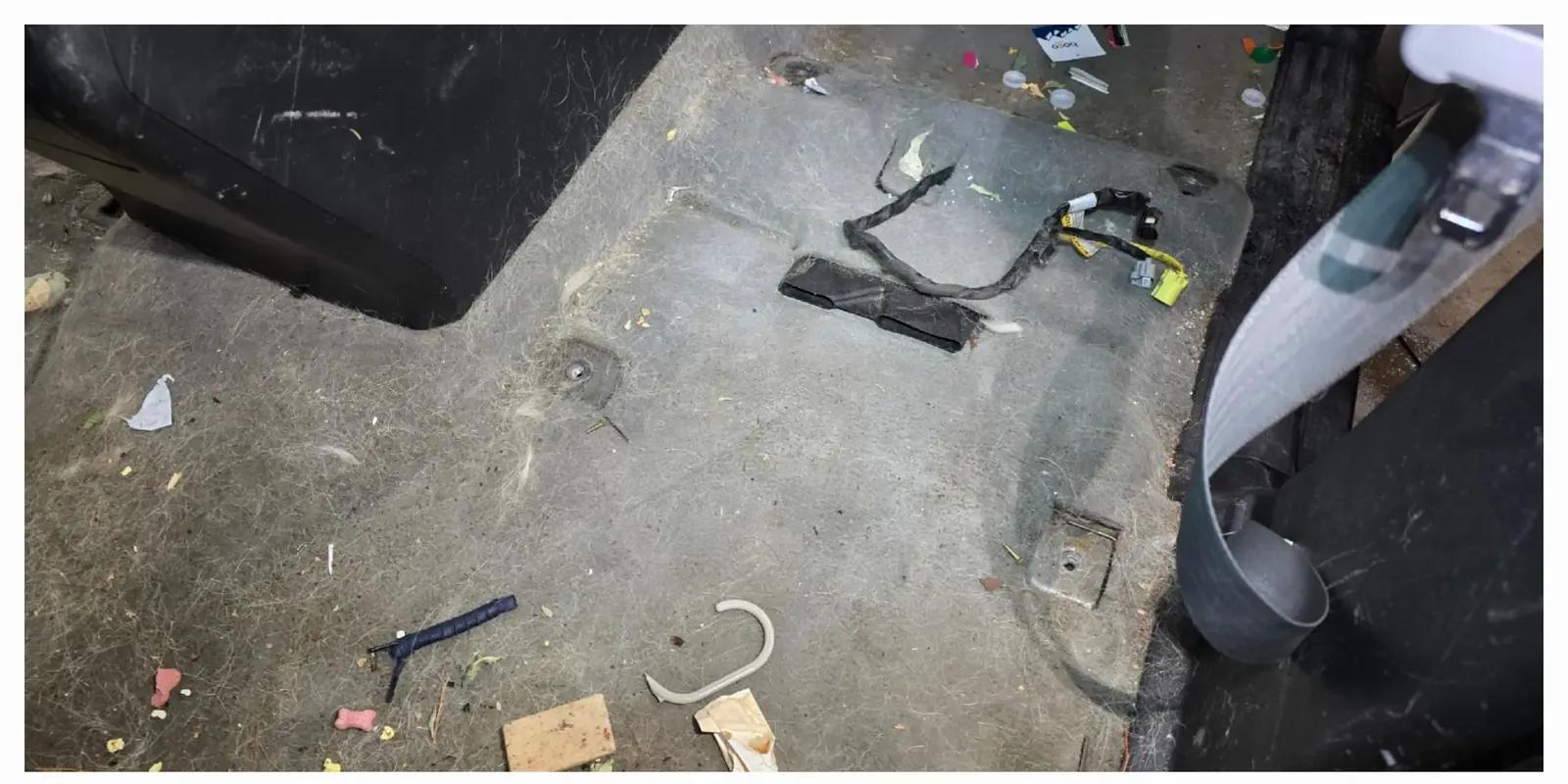 SUV carpet covered in pet hair and debris before interior detailing in Anchorage, Alaska