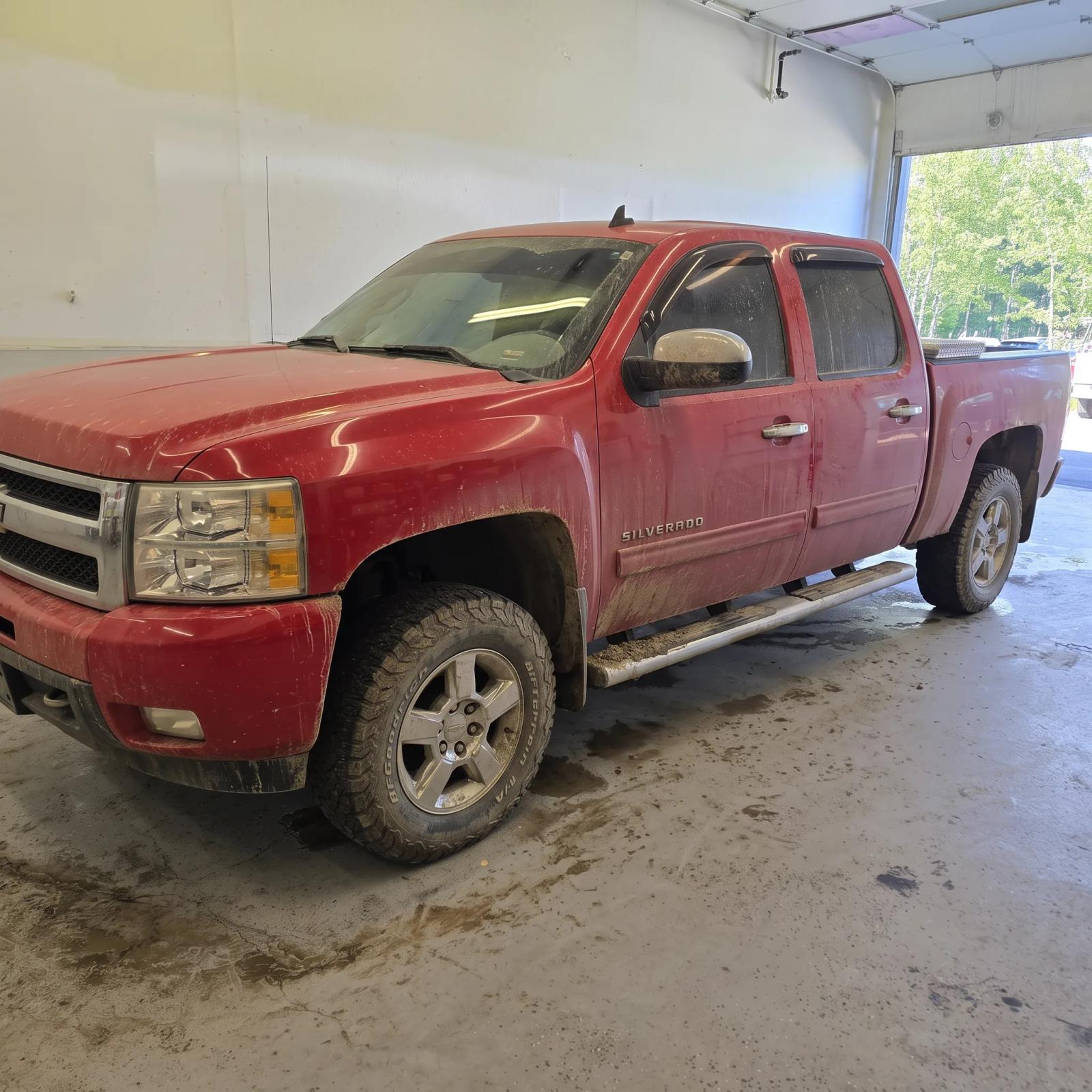 Chevrolet Silverado covered in road grime before exterior detailing in Anchorage, Alaska