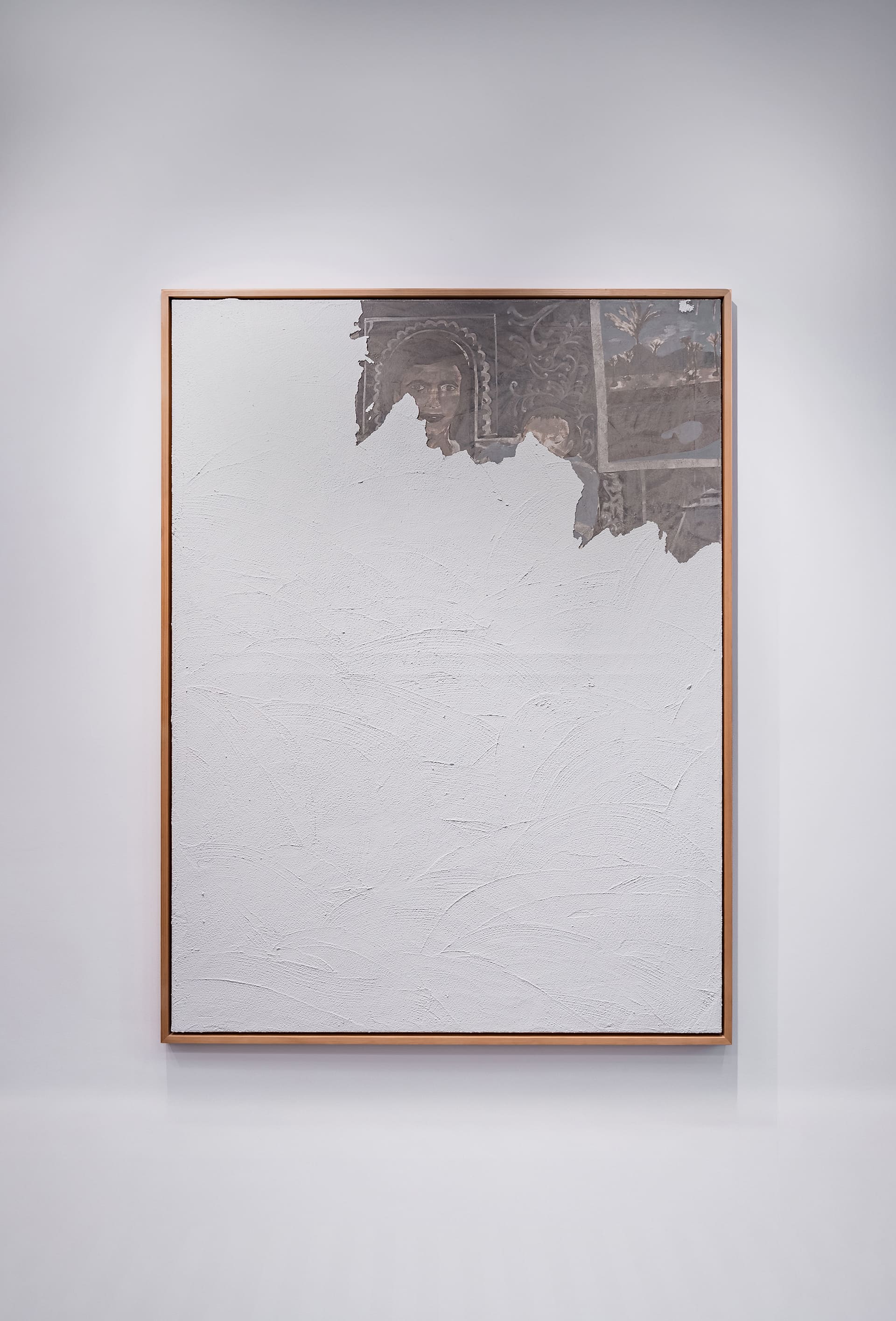 Large framed painting with a predominantly textured white surface. Along the top, torn-looking areas reveal an underlayer in muted browns, grays, and sepia tones, showing partially visible human faces and ornate decorative patterns, as if fragments of an aged mural are emerging through the white expanse.