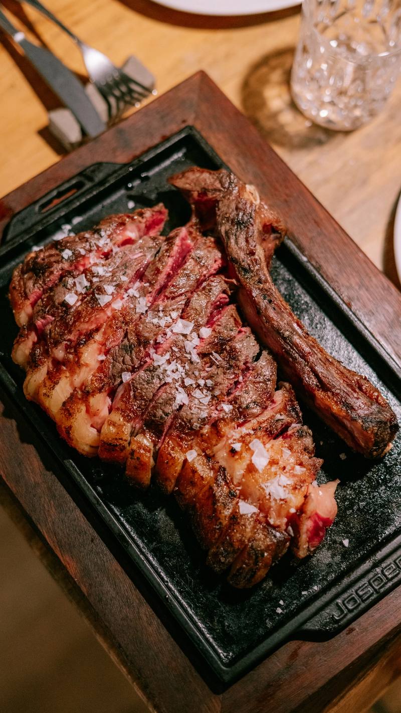 Chuletón a la brasa cortado en tiras con escamas de sal, en una plancha de hierro