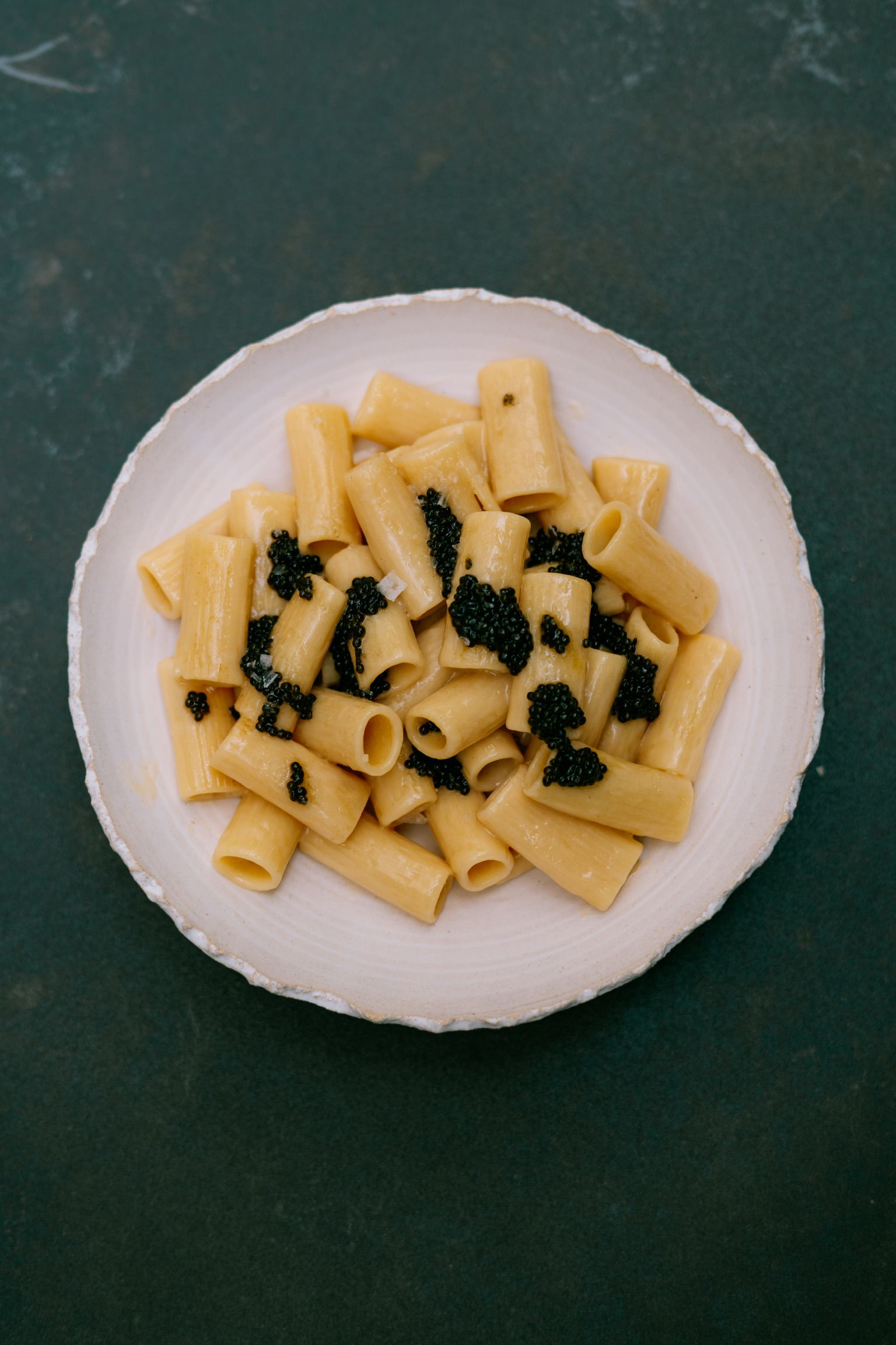 Plate of rigatoni with caviar seen from above