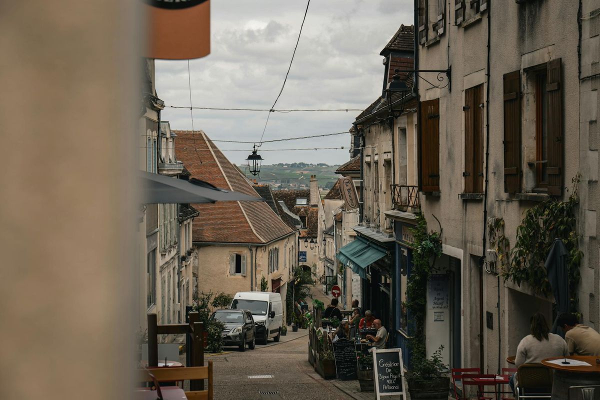 Explore the rustic charm and local dining atmosphere on a historic street in Sancerre, France.