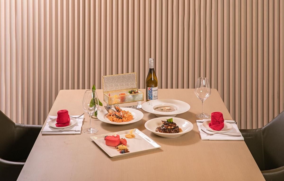 A beautifully arranged dining table with gourmet dishes, offering a fine dining experience with elegant presentation.