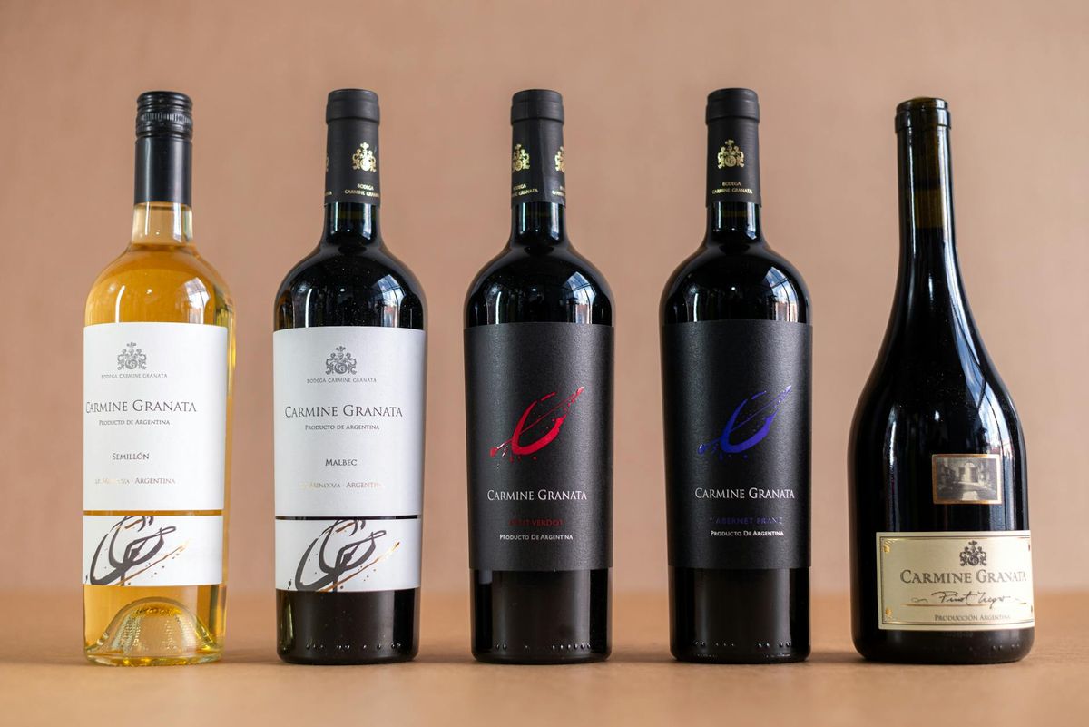 Studio shot of Carmine Granata wine bottles showcasing various types, set against a plain background.