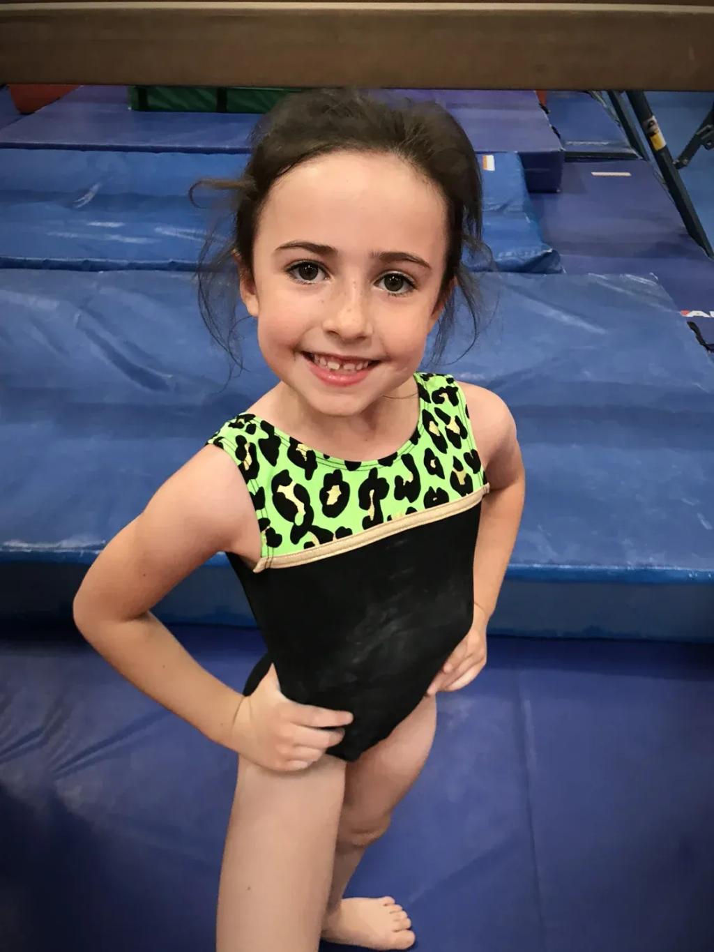 Gymnast holding a handstand during a Comets beginner class