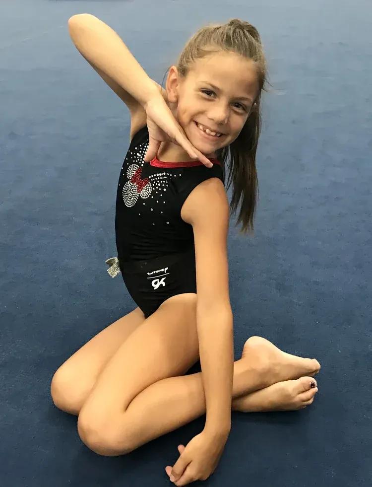 Brown's compulsory team gymnast performing a routine in competition