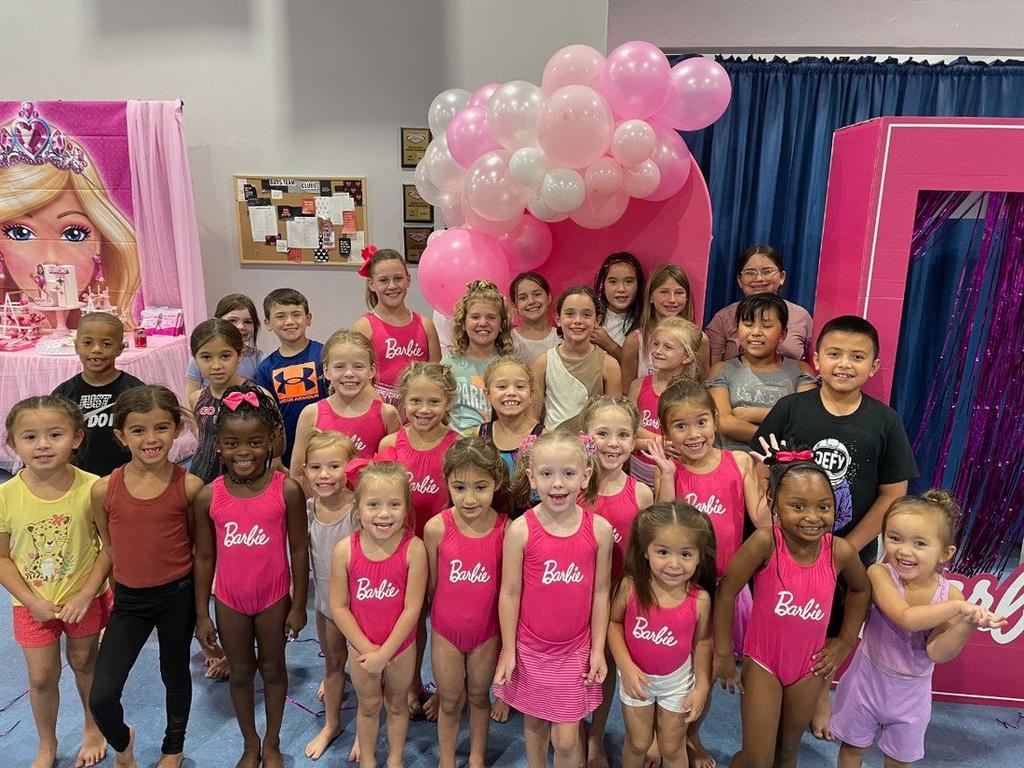 Birthday party group with balloon arch at Go For It USA