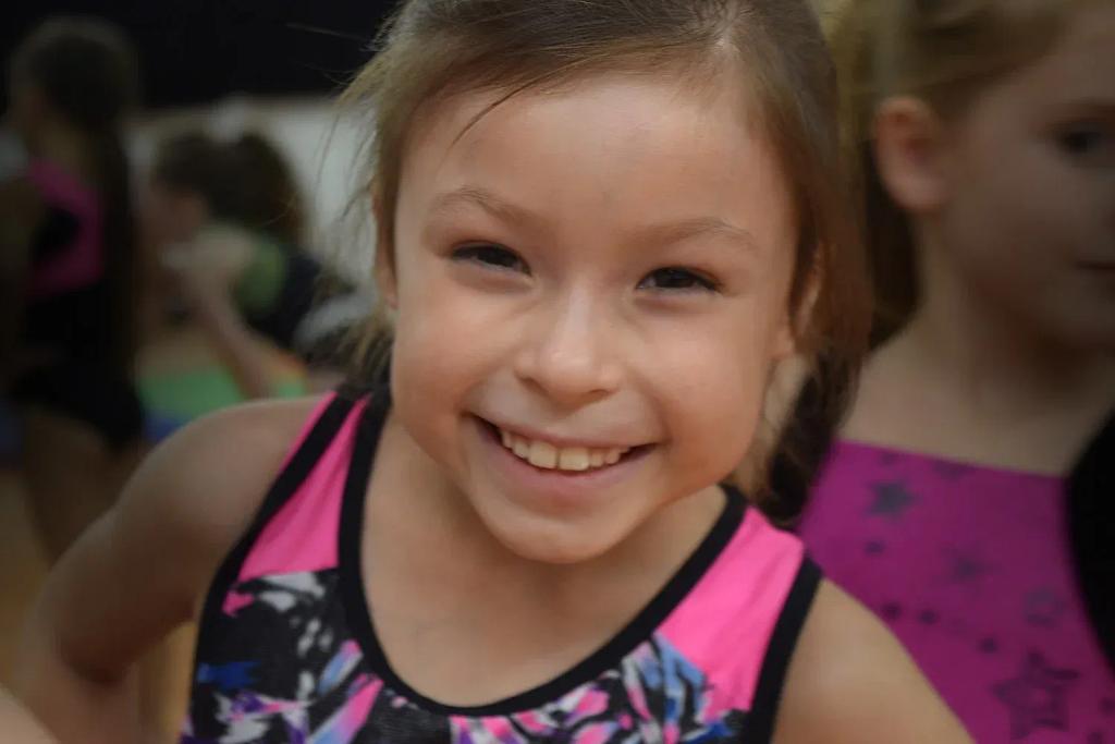 Gymnast practicing a rolling skill in a Meteors beginner class