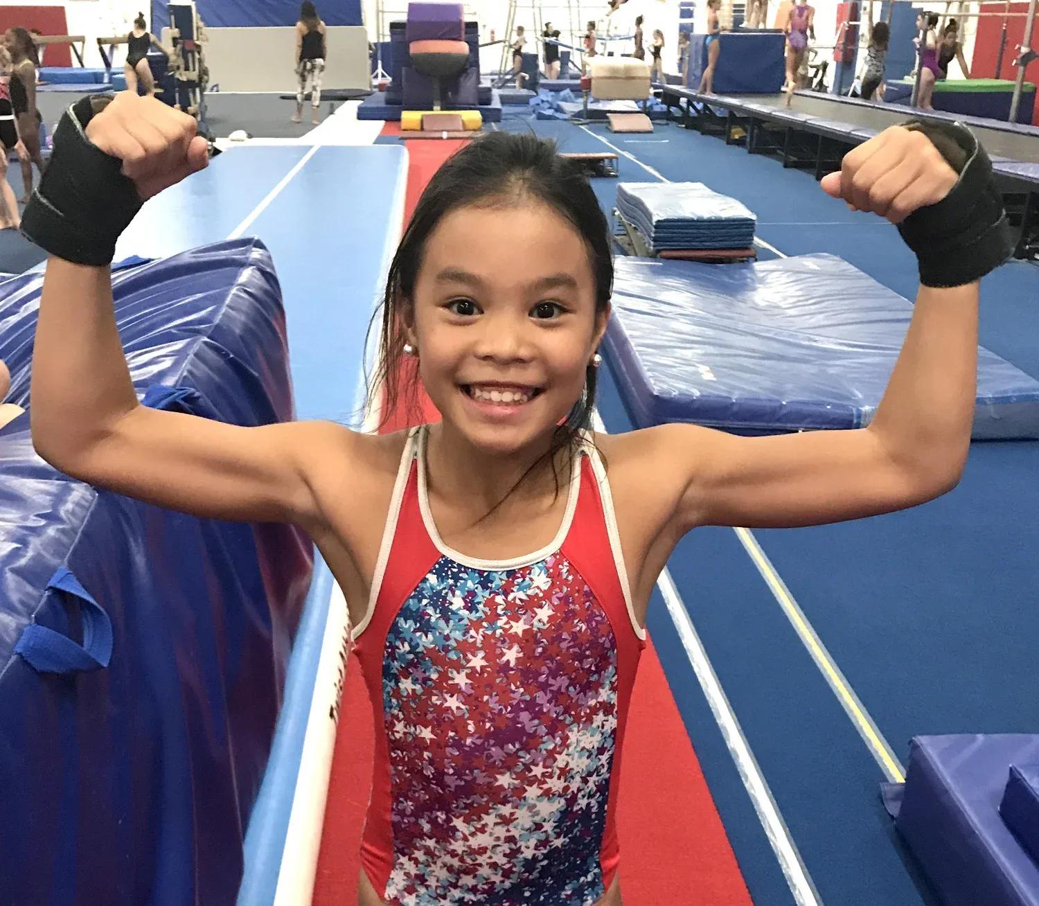 Gymnast conditioning at a strength station to build core and upper-body strength
