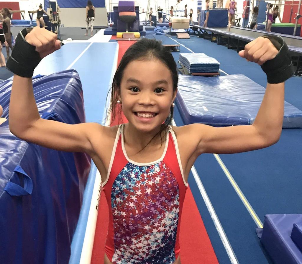 Gymnast conditioning at a strength station to build core and upper-body strength