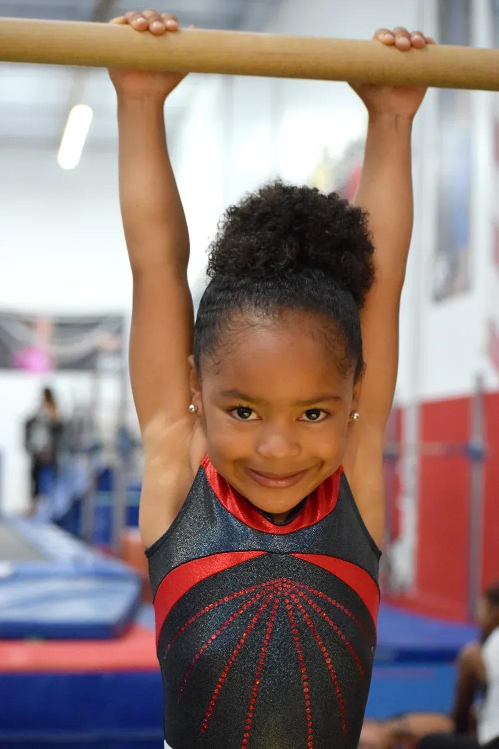 Brown's gymnast training at a competitive level in the invitation-only program