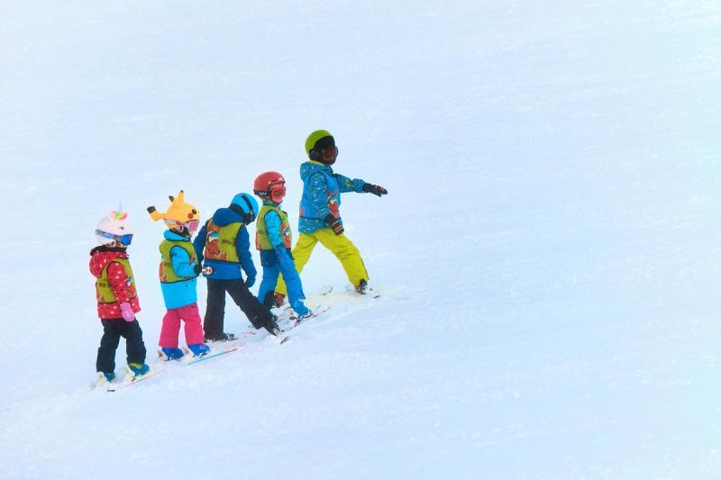 Kids in a line at ski resort